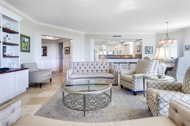 living room featuring a chandelier and ornamental molding