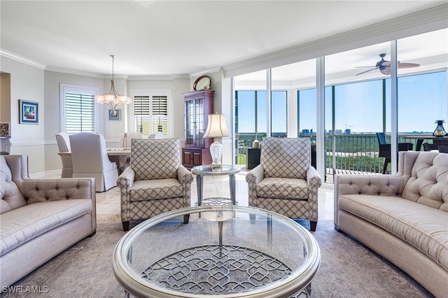 living room featuring ceiling fan with notable chandelier and ornamental molding