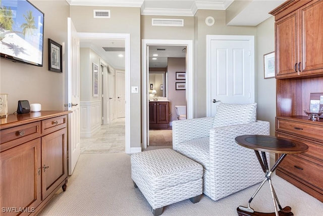 interior space with light colored carpet, crown molding, and ensuite bath