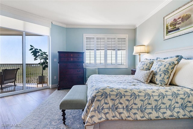 bedroom featuring hardwood / wood-style floors, ornamental molding, and access to outside