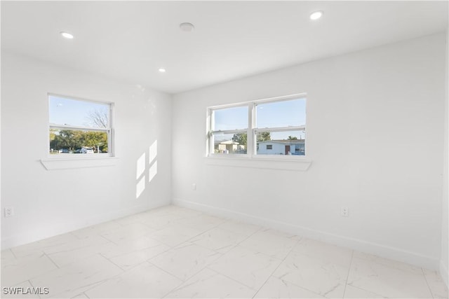 unfurnished room featuring a wealth of natural light