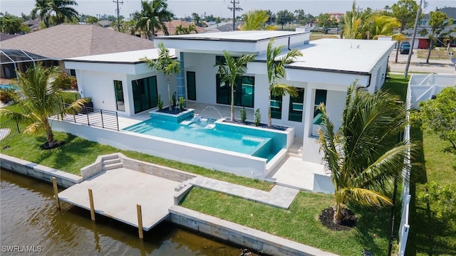 rear view of property with a patio area and a water view