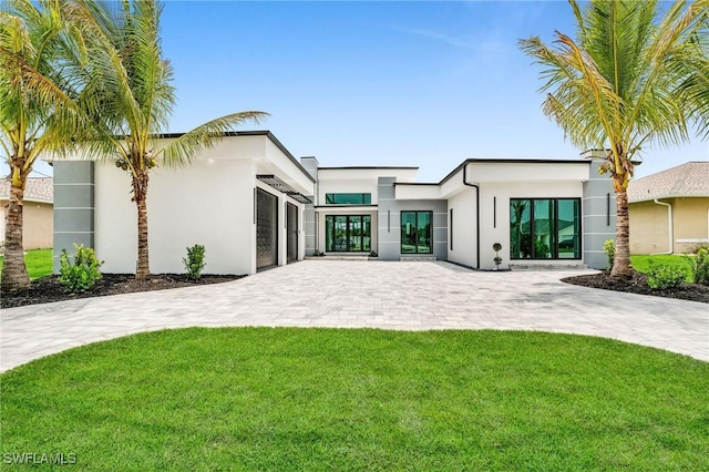 back of property with a yard and french doors