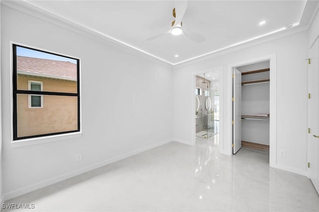 unfurnished bedroom with ensuite bath, ceiling fan, a closet, and ornamental molding