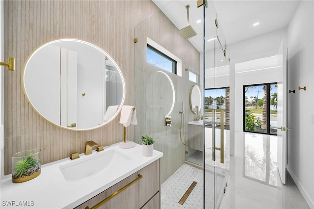 bathroom featuring tile patterned floors, vanity, and a shower with shower door