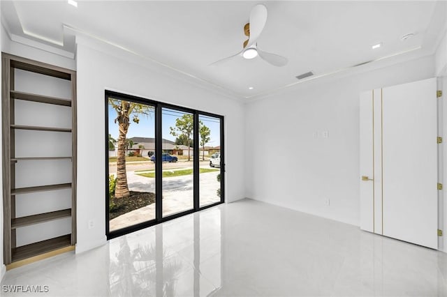 spare room featuring ceiling fan and ornamental molding