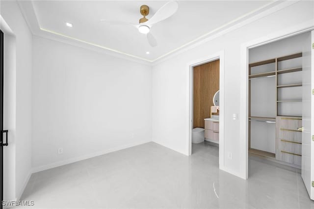 unfurnished bedroom featuring ceiling fan, crown molding, and a closet