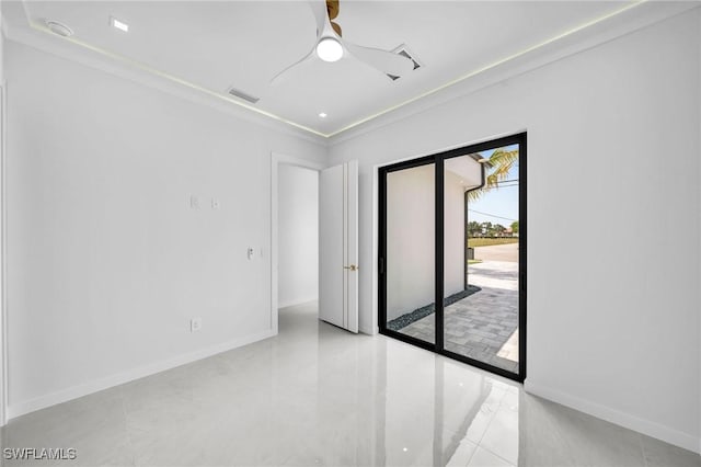 spare room with ceiling fan and crown molding