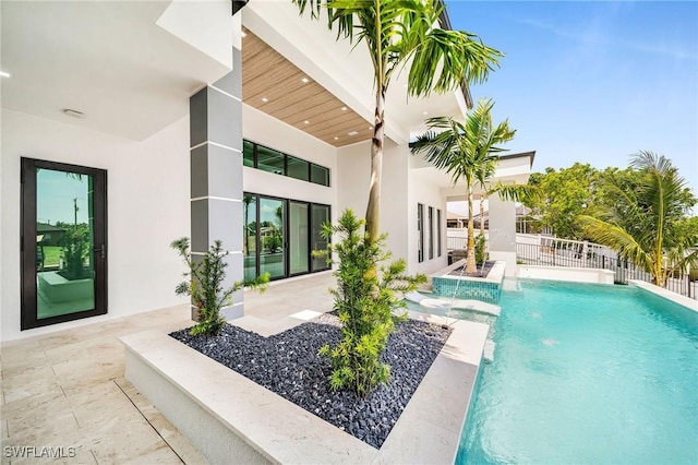 view of pool with pool water feature and a patio