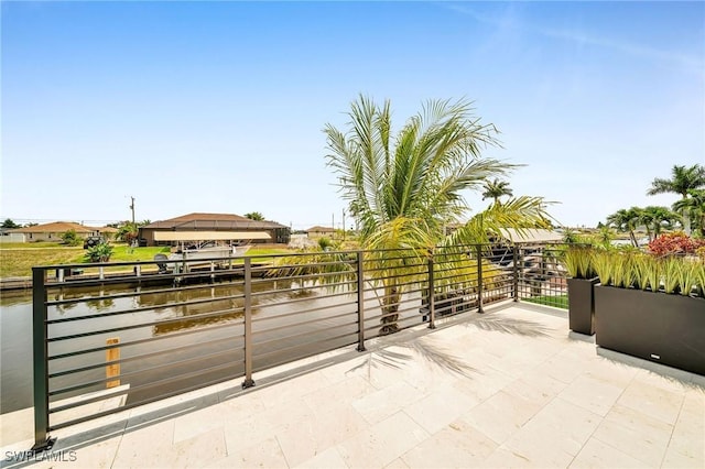 view of patio / terrace featuring a balcony and a water view