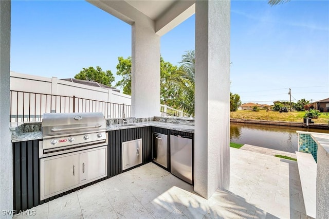 view of patio / terrace with area for grilling and a water view