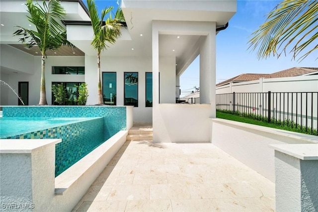 view of pool featuring pool water feature and a patio area