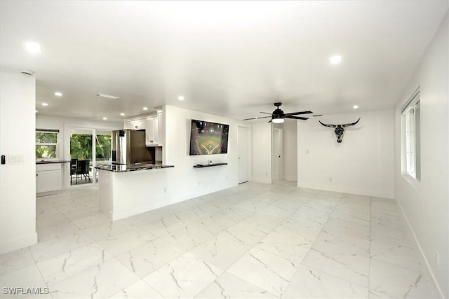 unfurnished living room featuring ceiling fan