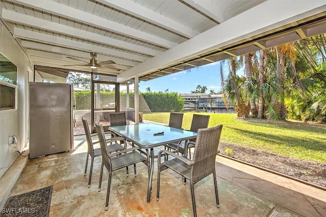 sunroom featuring ceiling fan, beamed ceiling, and a water view