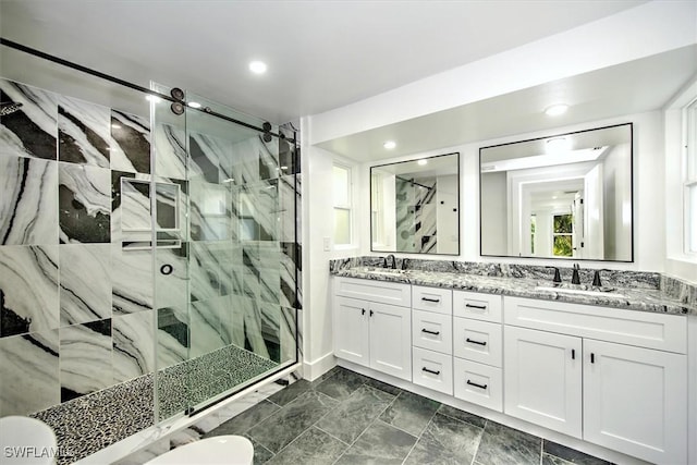 bathroom with vanity and a shower with shower door