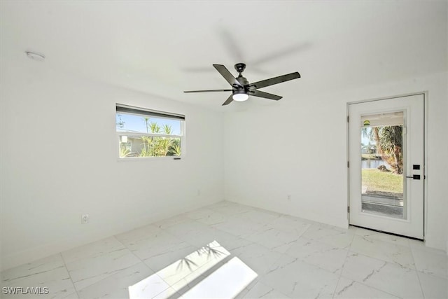 empty room featuring ceiling fan and a healthy amount of sunlight