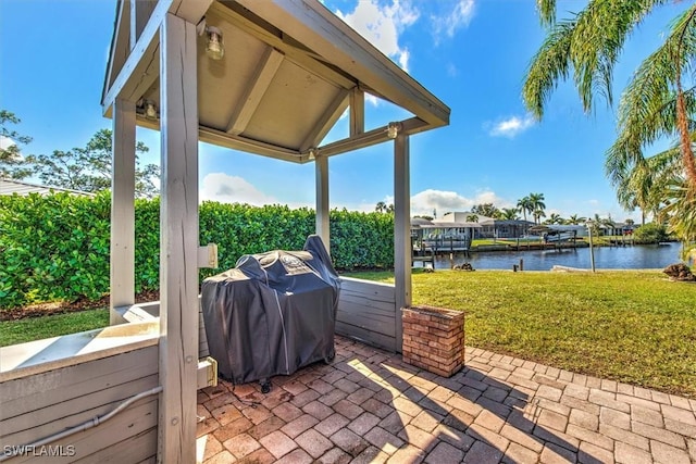 view of patio / terrace with a water view and area for grilling