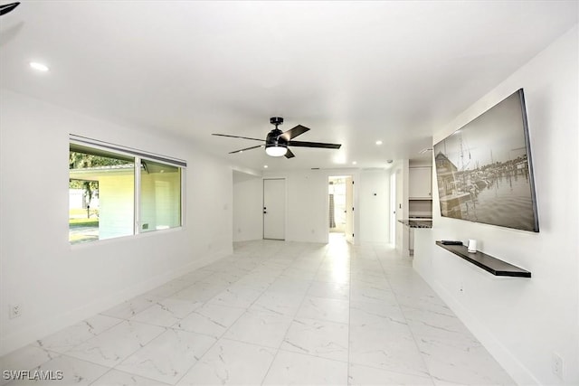 unfurnished living room with ceiling fan