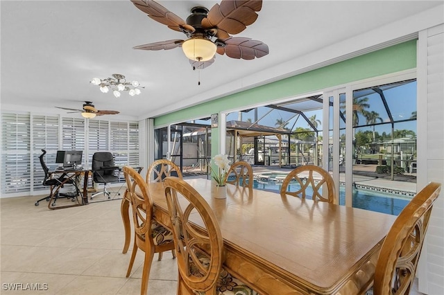 dining area with a ceiling fan, a sunroom, and light tile patterned floors