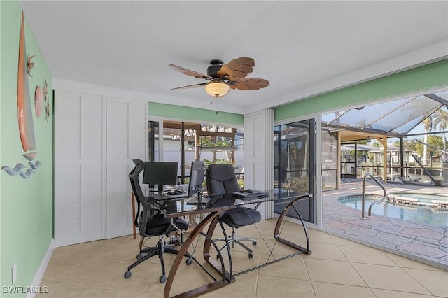 tiled home office featuring ceiling fan