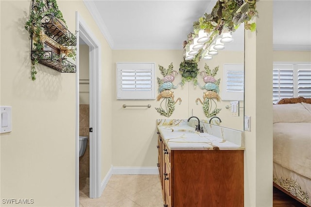 bathroom featuring tile patterned flooring, vanity, toilet, and crown molding