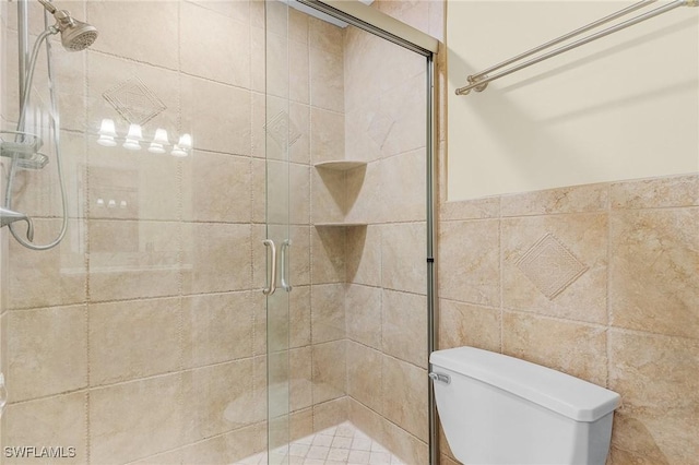 bathroom featuring toilet and an enclosed shower