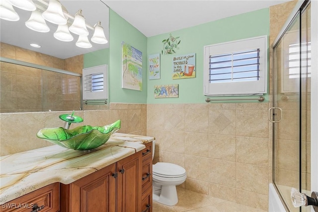 full bathroom featuring vanity, tile patterned floors, plenty of natural light, and tile walls