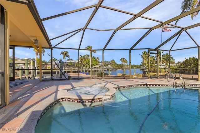 view of swimming pool with a pool with connected hot tub, a lanai, a patio area, and a water view