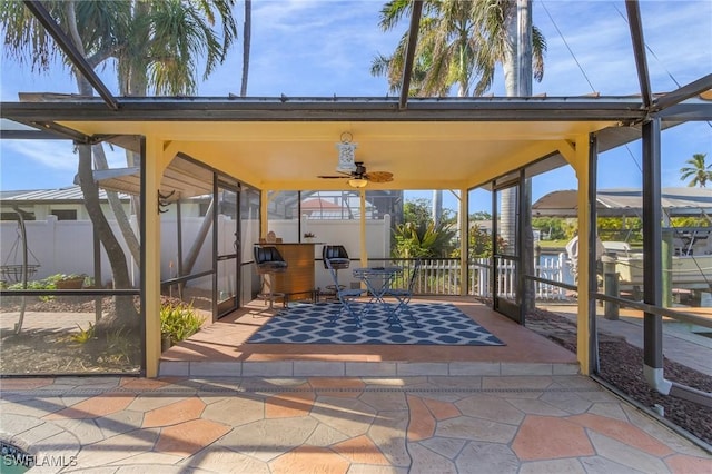 view of patio with a lanai and fence