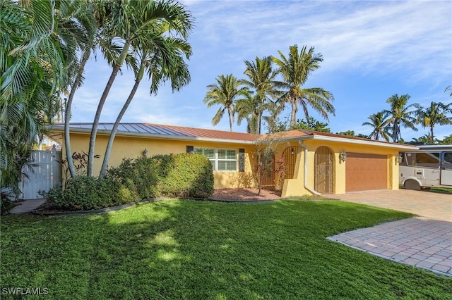 view of front of home featuring a garage and a front yard