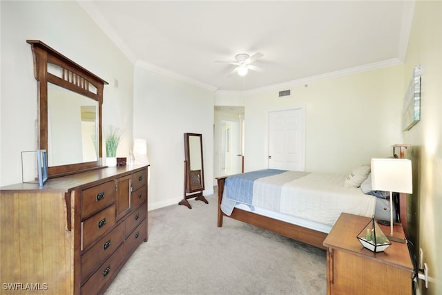 carpeted bedroom with ceiling fan and crown molding