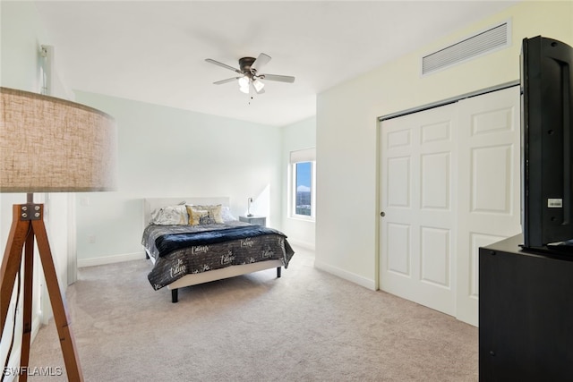 carpeted bedroom with a closet and ceiling fan