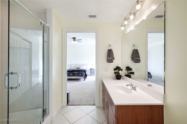 bathroom featuring tile patterned flooring, vanity, ceiling fan, and walk in shower