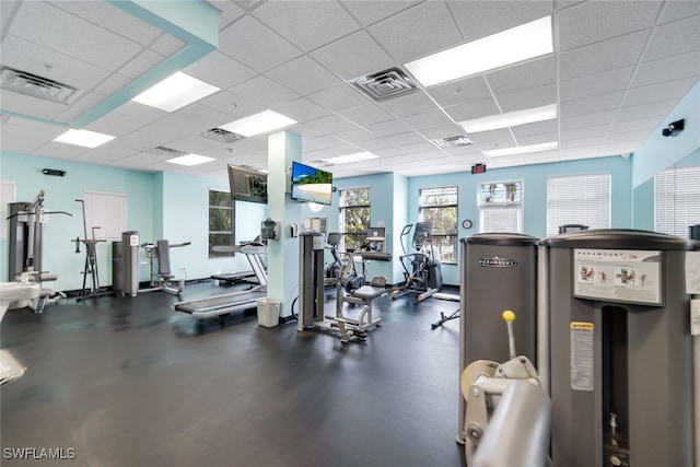 gym with a paneled ceiling