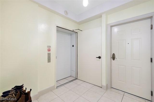 tiled entrance foyer featuring elevator