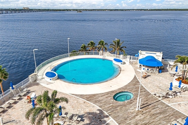 view of pool featuring a patio area and a water view