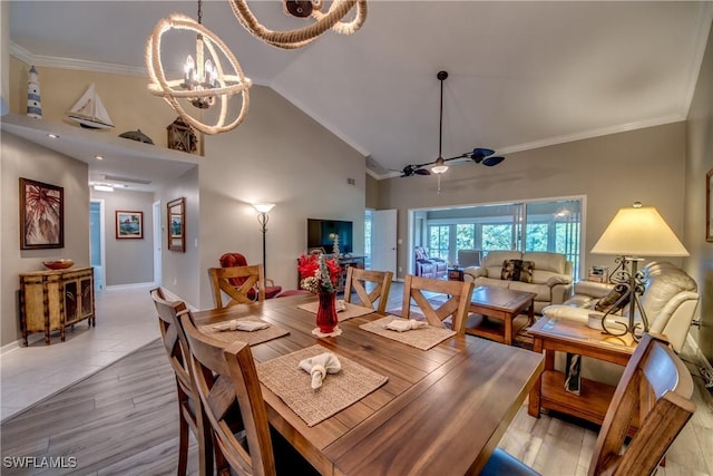 dining area featuring ceiling fan with notable chandelier, light wood-type flooring, vaulted ceiling, and ornamental molding