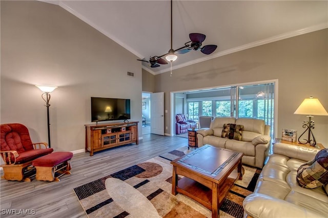 living room featuring light wood-type flooring, high vaulted ceiling, ceiling fan, and ornamental molding