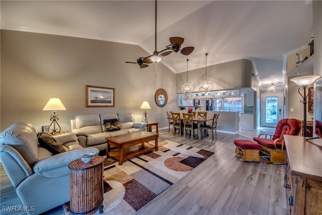 living room with hardwood / wood-style flooring, ceiling fan, ornamental molding, and vaulted ceiling