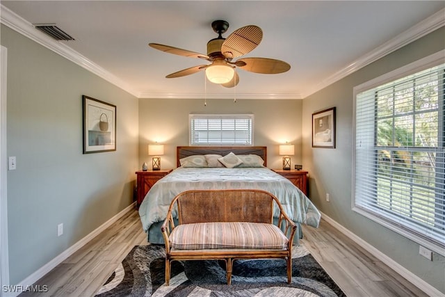 bedroom featuring ceiling fan, light hardwood / wood-style flooring, and ornamental molding