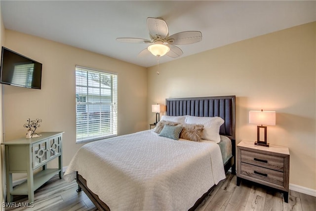 bedroom with ceiling fan and light hardwood / wood-style floors