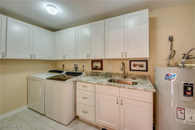 laundry room featuring washing machine and dryer, electric water heater, sink, and cabinets