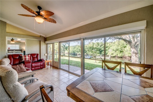 sunroom featuring ceiling fan, plenty of natural light, and vaulted ceiling