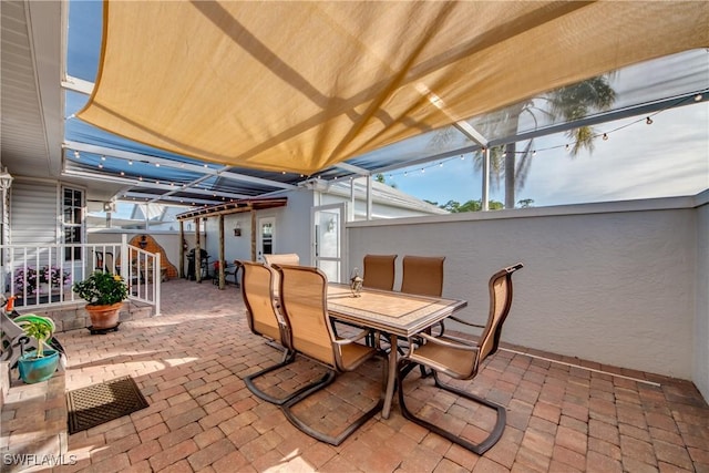 view of patio / terrace featuring a lanai