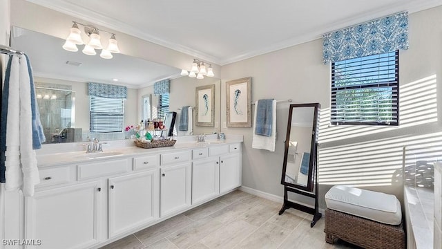 bathroom with vanity, a shower with shower door, a healthy amount of sunlight, and a notable chandelier