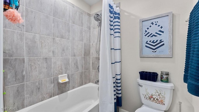 bathroom with shower / bath combo and toilet