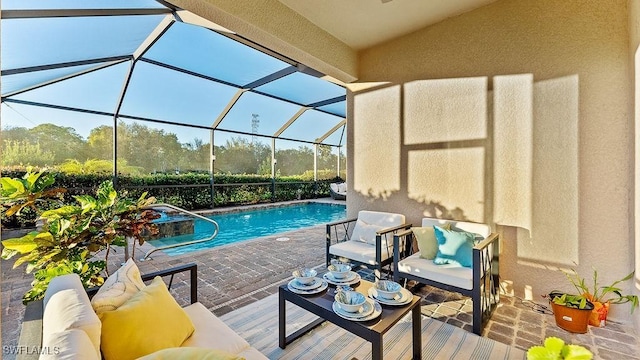 view of swimming pool featuring a lanai and a patio