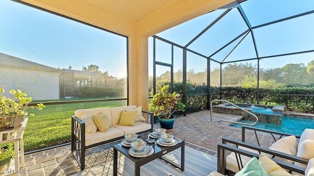 view of patio with outdoor lounge area and glass enclosure