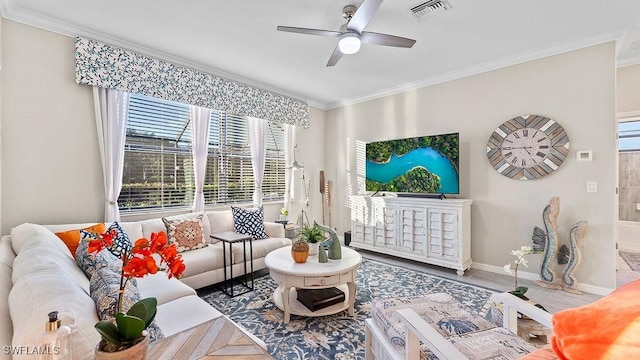 living room featuring parquet flooring, ceiling fan, and ornamental molding