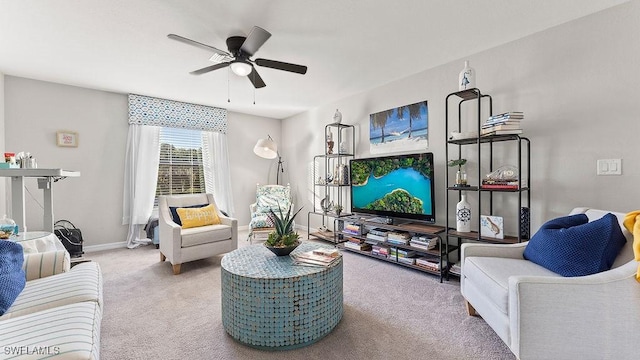 carpeted living room with ceiling fan